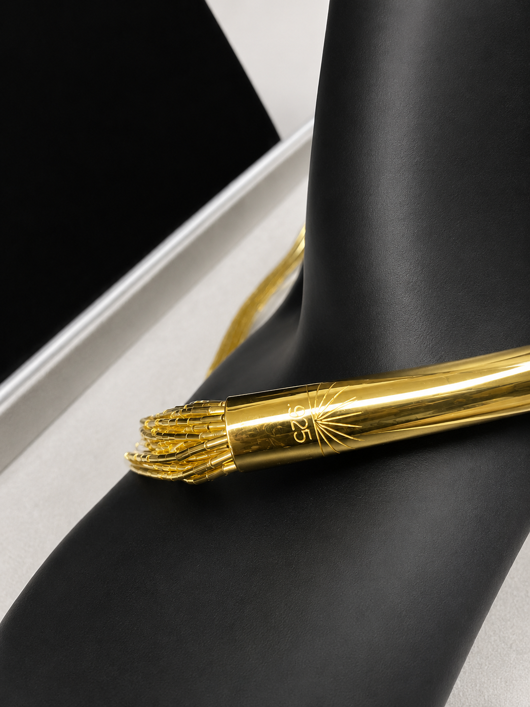 This is a striking gold over sterling silver necklace, featuring the iconic liquid-sterling design. The fluid, sculptural form creates visual movement and dimension, while the gold overlay adds warmth and luxury to the cool brilliance of sterling silver. With substantial length and thickness, this piece commands attention as a standalone statement.