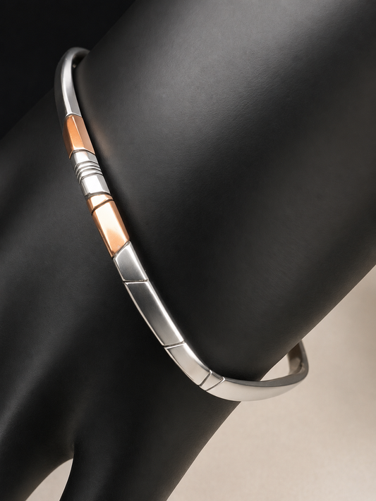 Here is an elegant vintage sterling silver bracelet featuring inlaid copper accents and hand-etched detailing. The distinctive rectangular design creates a modern yet timeless aesthetic, making this piece a standout addition to any jewelry collection.