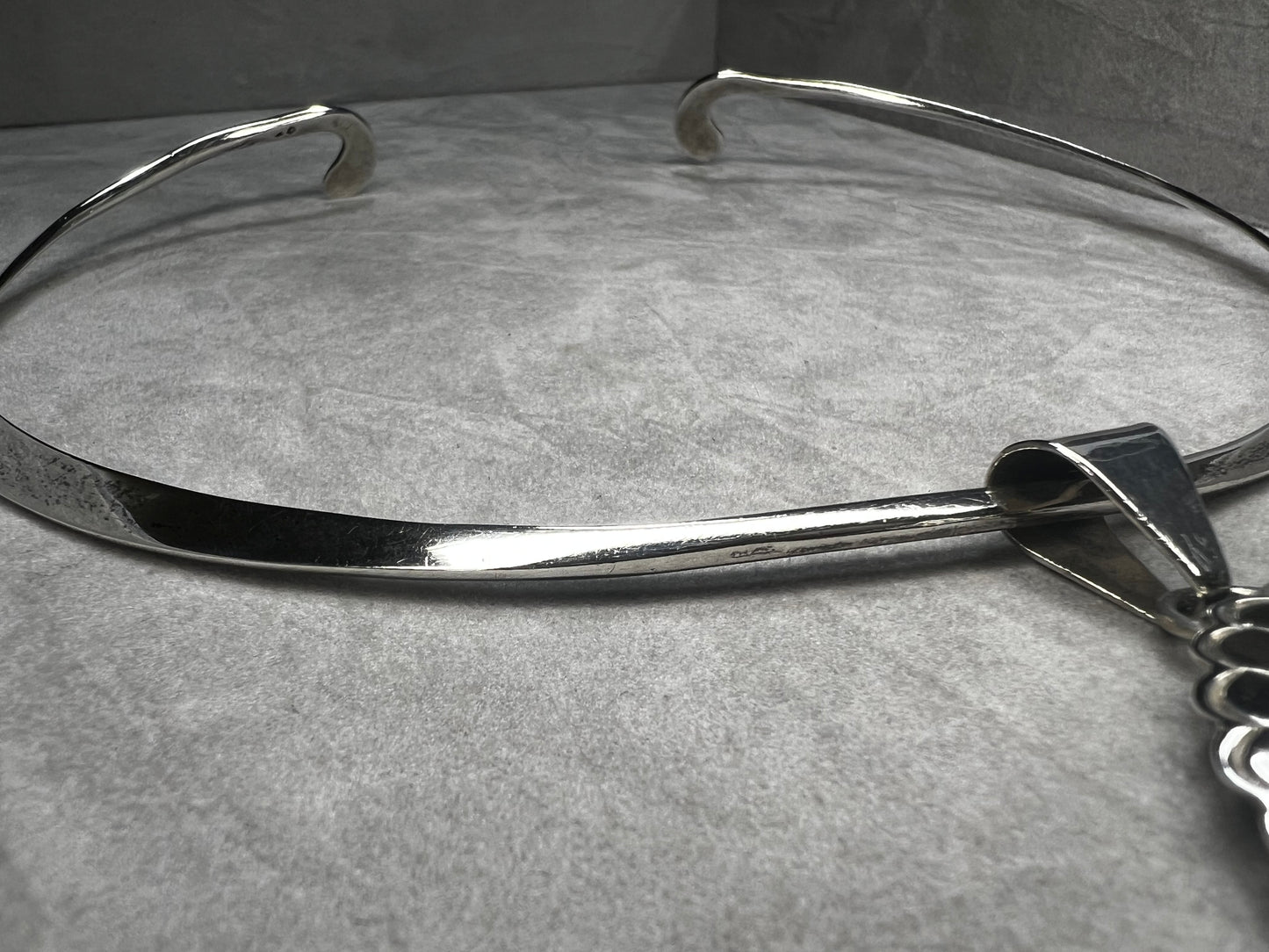 This slide pendant necklace features a large onyx and sterling pendant front and center with a sterling collar. From native American silversmith L. James.