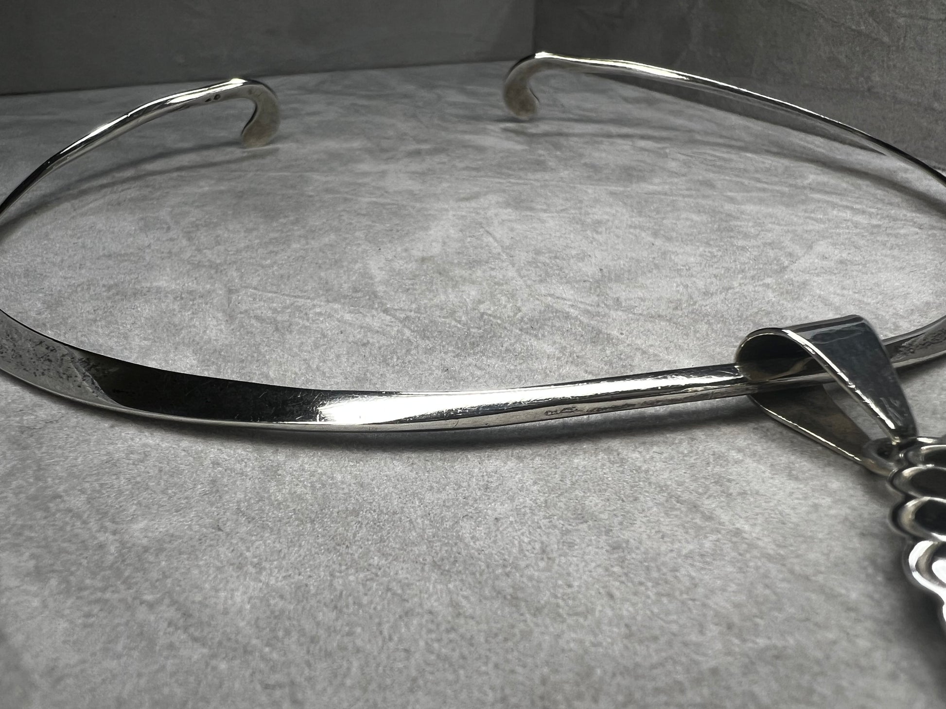 This slide pendant necklace features a large onyx and sterling pendant front and center with a sterling collar. From native American silversmith L. James.