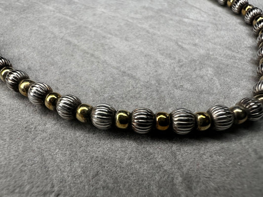 Made of sterling silver beads with alternating gold overlay, this is a nice short necklace that needs no pendant.