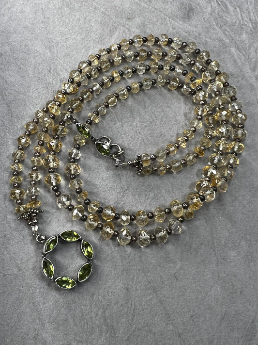 This necklace combines sterling silver with finely faceted translucent citrine beads, accented by a distinctive peridot toggle clasp. Its unique design offers a timeless elegance that complements any outfit.