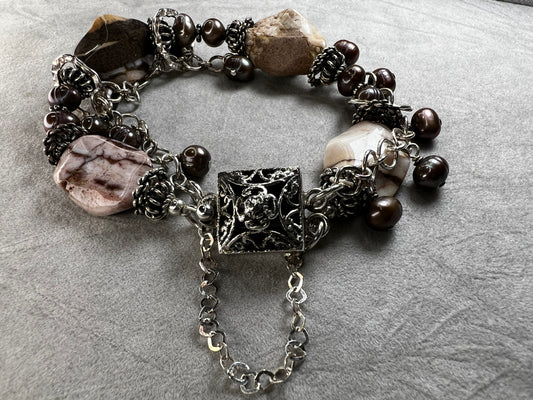 This bracelet combines quality craftsmanship with elegant design. Made from sterling silver and natural stone, it offers graceful movement on your wrist.