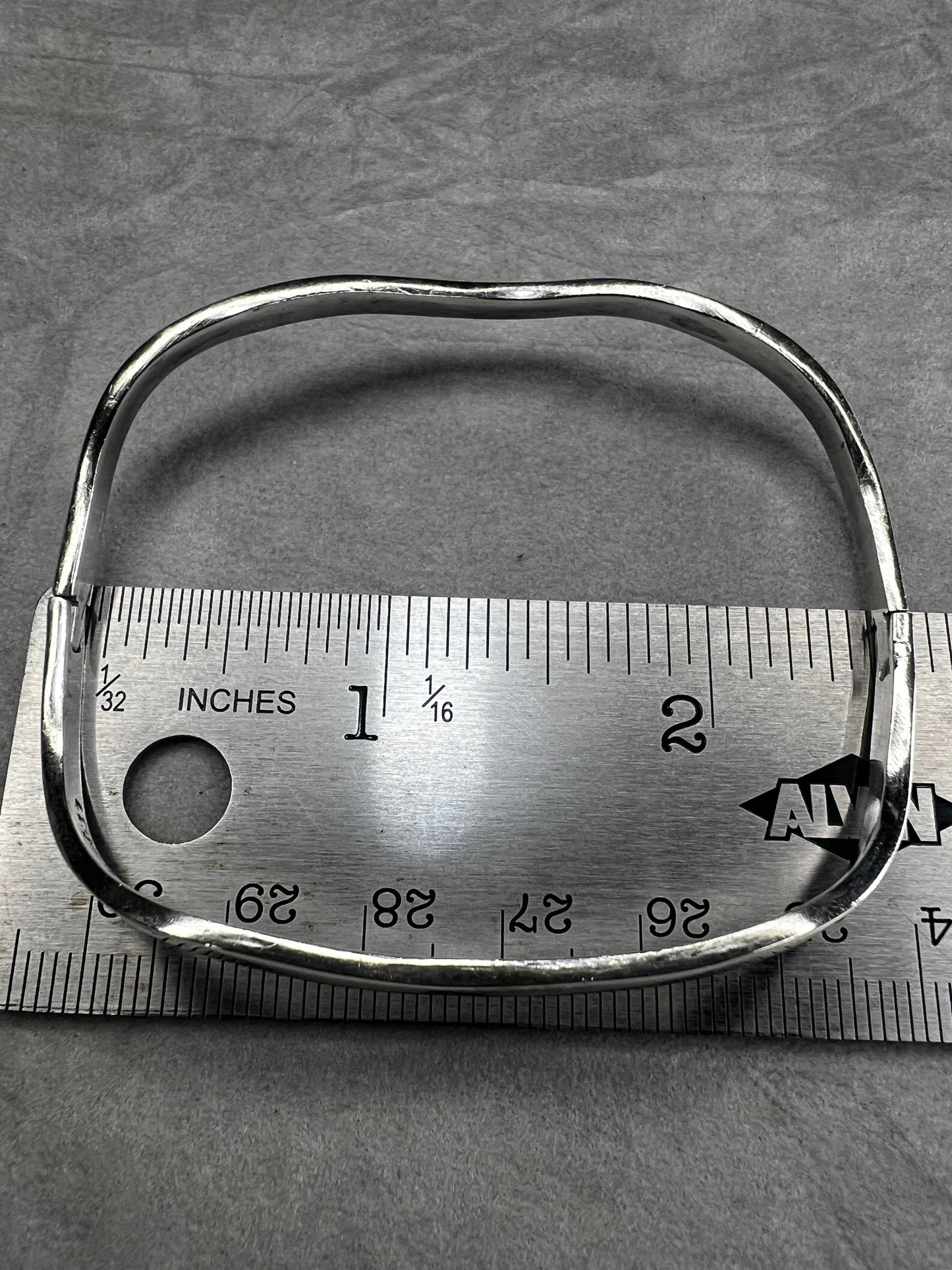 This vintage Taxco sterling silver bracelet features a distinctive wavy design and is marked TM-37, showcasing authentic craftsmanship from Mexico. Its timeless style makes it a versatile accessory for everyday wear or special occasions.