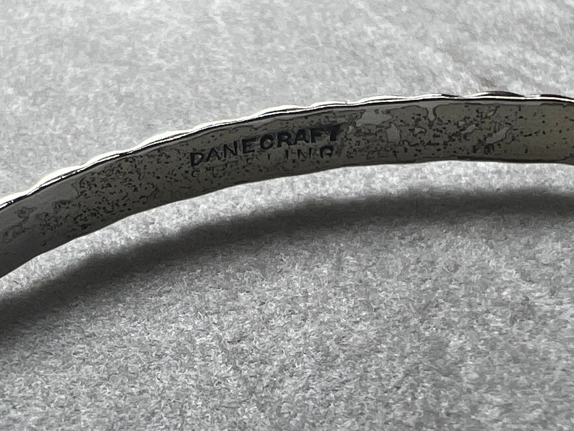 This vintage Danecraft sterling silver bracelet offers timeless elegance with its simple yet detailed design. Crafted with care, it provides a classic accessory that complements any outfit while ensuring durability and comfort for everyday wear.