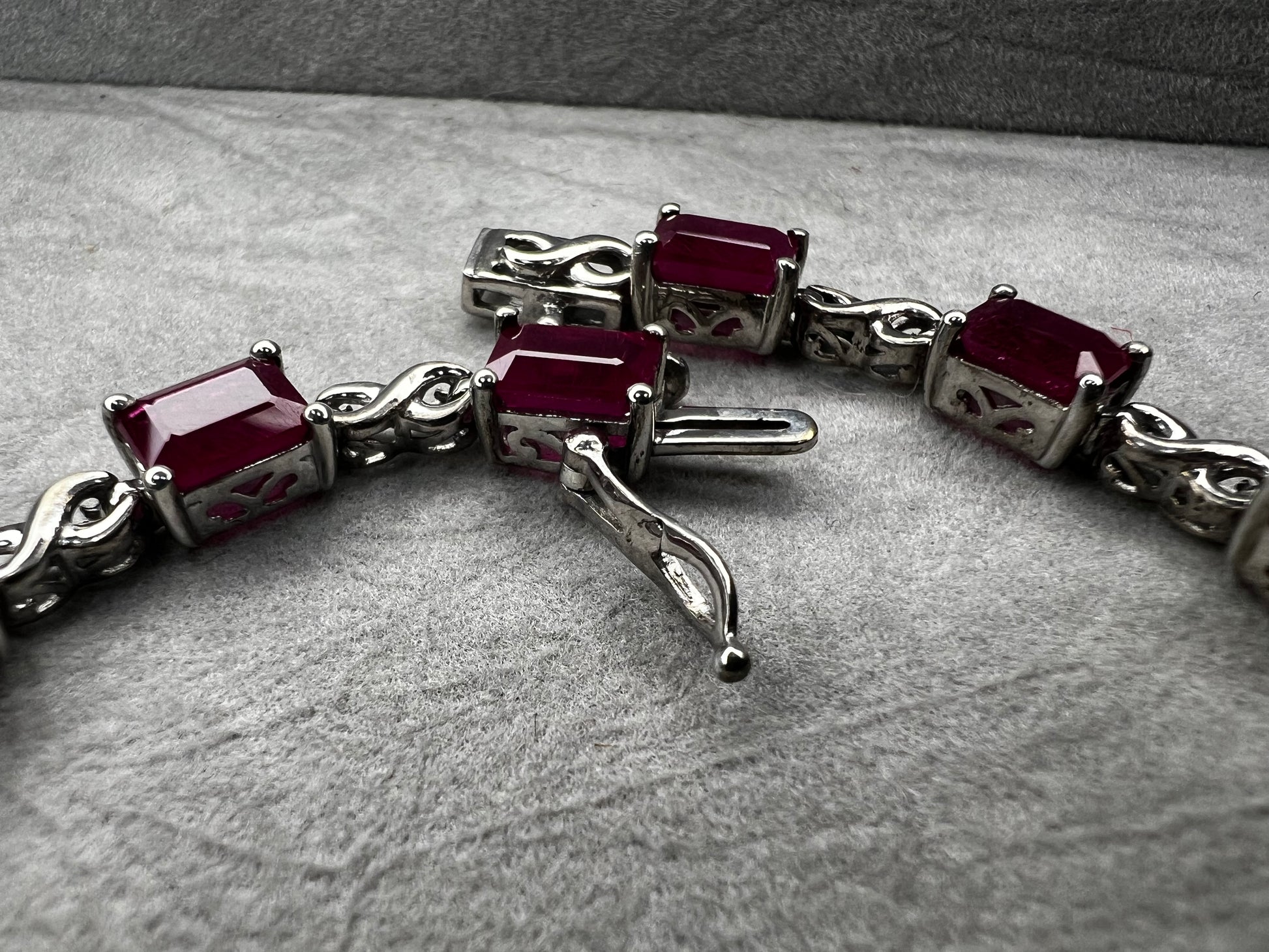 This bracelet is crafted from sterling silver and set with stunning lab-created rubies. It's a piece that's sure to enhance any outfit.