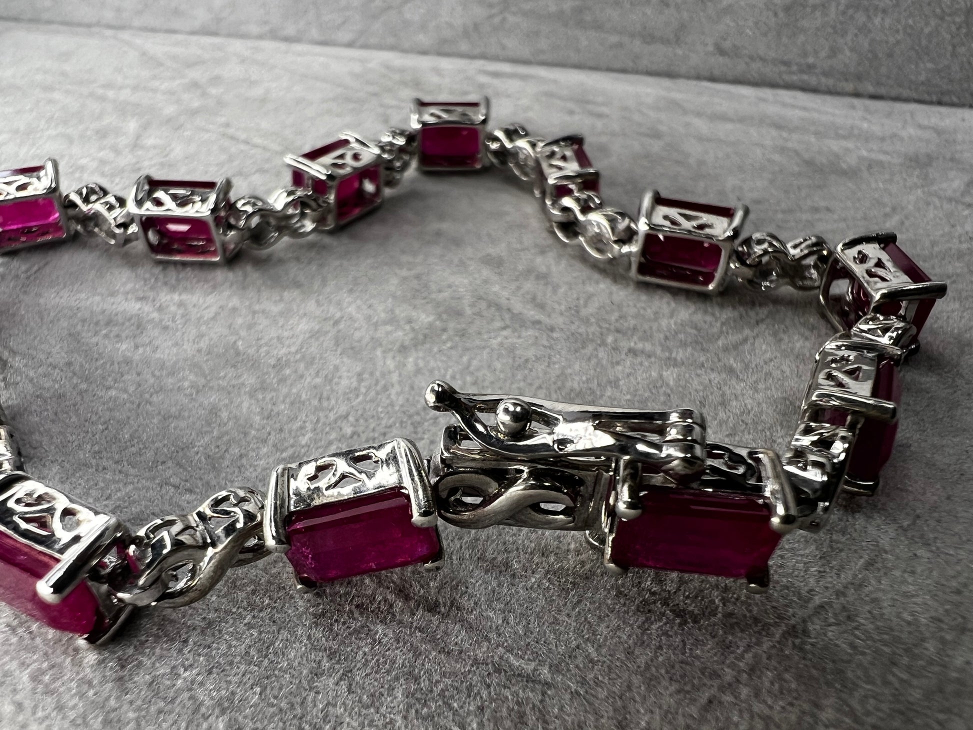 This bracelet is crafted from sterling silver and set with stunning lab-created rubies. It's a piece that's sure to enhance any outfit.