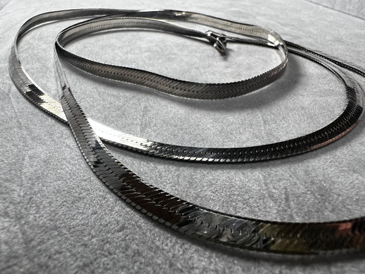 This sterling silver herringbone necklace combines length and strength with refined elegance. Ideal for those seeking a longer chain, it provides a graceful drape while offering the durability needed to support larger pendants with confidence and style.