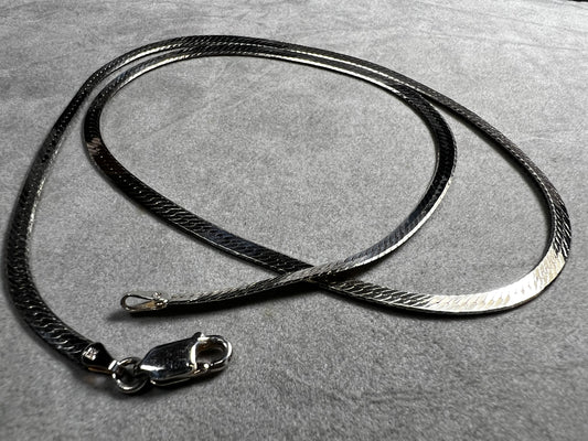 This classic sterling silver herringbone necklace will add just the right touch of shine to your outfit.