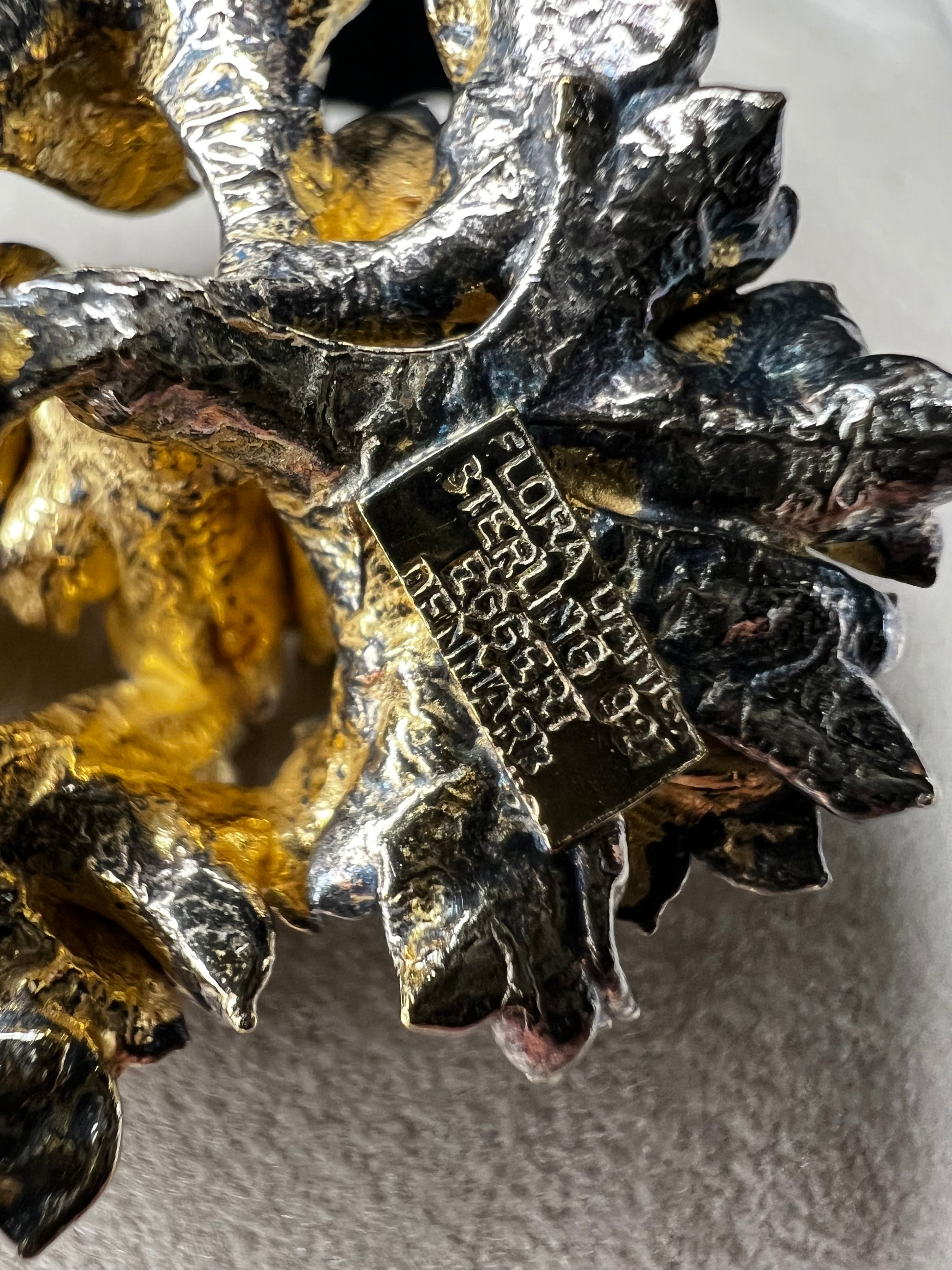 This is an elegant mid-century Flora Danica parsley brooch handcrafted in sterling silver with a warm gold-wash finish. It's a timeless accessory perfect for collectors of vintage Scandinavian jewelry or anyone who appreciates fine craftsmanship and nature-inspired design. Signed Eggert Denmark.