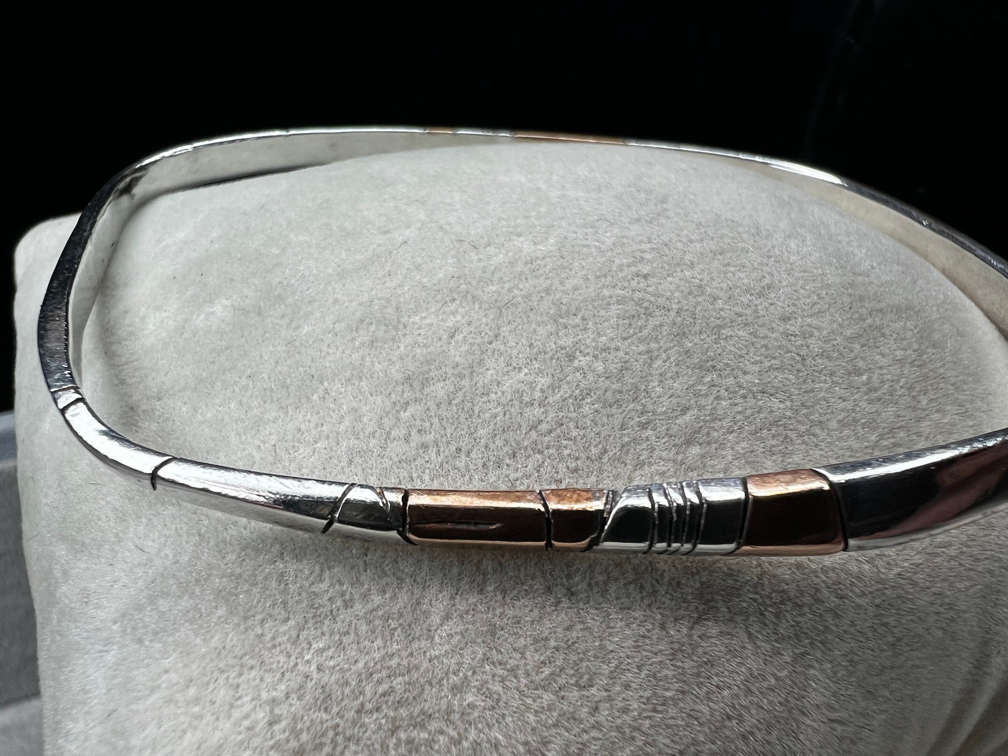 Here is an elegant vintage sterling silver bracelet featuring inlaid copper accents and hand-etched detailing. The distinctive rectangular design creates a modern yet timeless aesthetic, making this piece a standout addition to any jewelry collection.