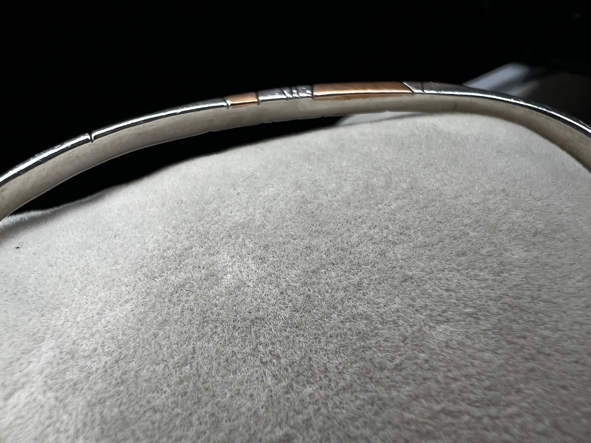 Here is an elegant vintage sterling silver bracelet featuring inlaid copper accents and hand-etched detailing. The distinctive rectangular design creates a modern yet timeless aesthetic, making this piece a standout addition to any jewelry collection.