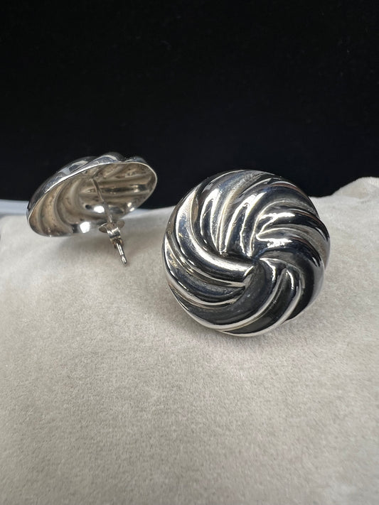 These earrings, expertly crafted from sterling silver, are designed to reflect light with every movement. Their polished finish adds a subtle yet striking shimmer, making them a versatile accessory for both everyday wear and special occasions.