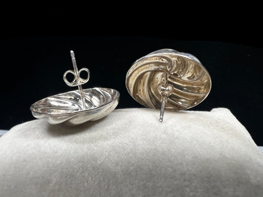 These earrings, expertly crafted from sterling silver, are designed to reflect light with every movement. Their polished finish adds a subtle yet striking shimmer, making them a versatile accessory for both everyday wear and special occasions.