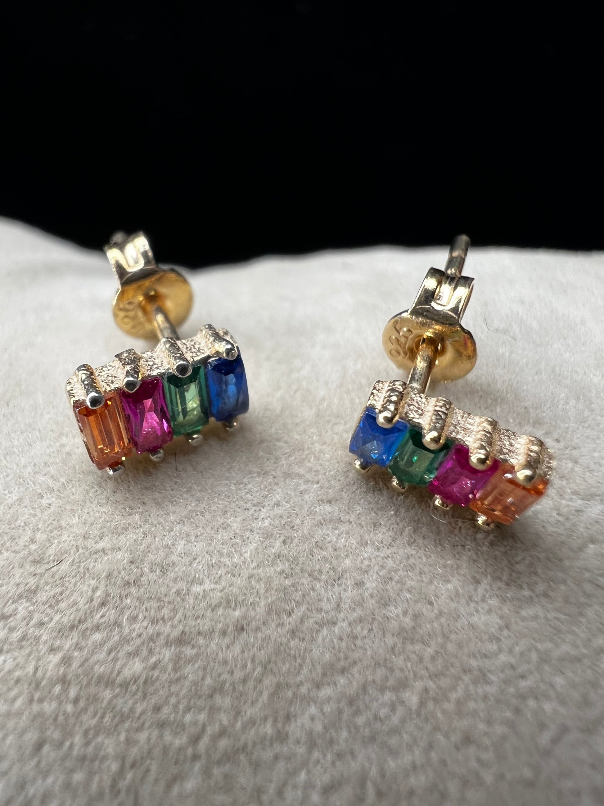 Elevate your everyday look with these stunning sterling silver earrings. They feature vibrant multi-colored stones set against a luxurious gold overlay. The perfect blend of elegance and versatility, these earrings add a pop of color and sophistication to any outfit. Crafted with quality materials, they're ideal for both casual wear and special occasions.