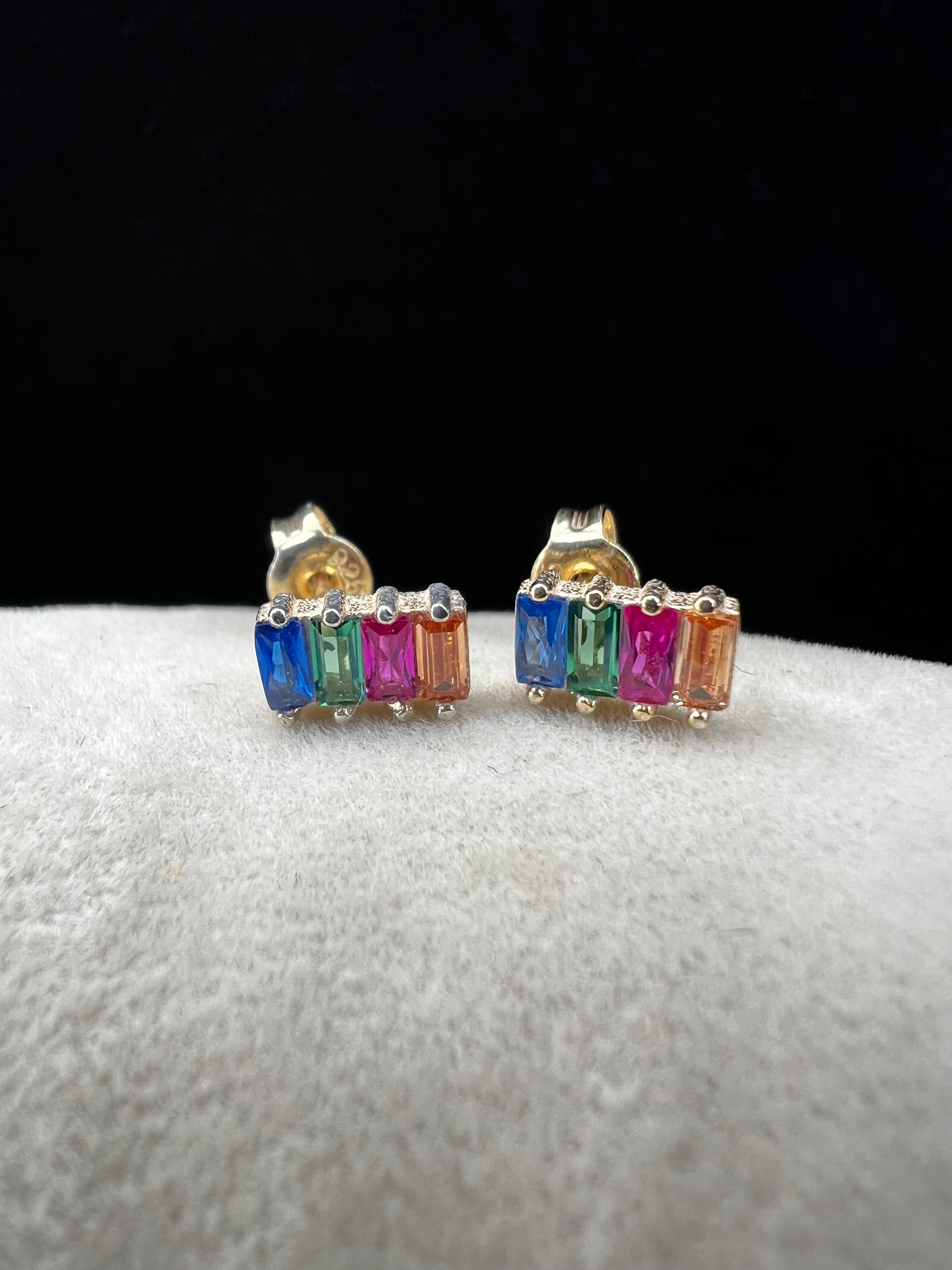 Elevate your everyday look with these stunning sterling silver earrings. They feature vibrant multi-colored stones set against a luxurious gold overlay. The perfect blend of elegance and versatility, these earrings add a pop of color and sophistication to any outfit. Crafted with quality materials, they're ideal for both casual wear and special occasions.
