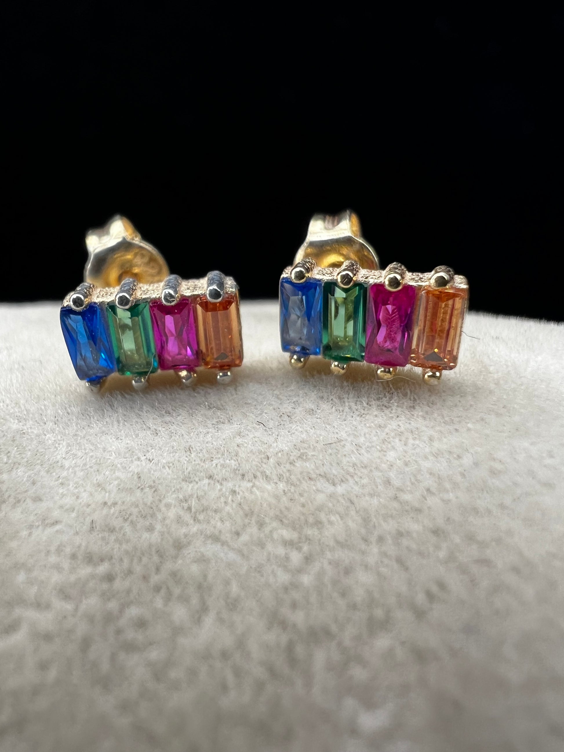 Elevate your everyday look with these stunning sterling silver earrings. They feature vibrant multi-colored stones set against a luxurious gold overlay. The perfect blend of elegance and versatility, these earrings add a pop of color and sophistication to any outfit. Crafted with quality materials, they're ideal for both casual wear and special occasions.