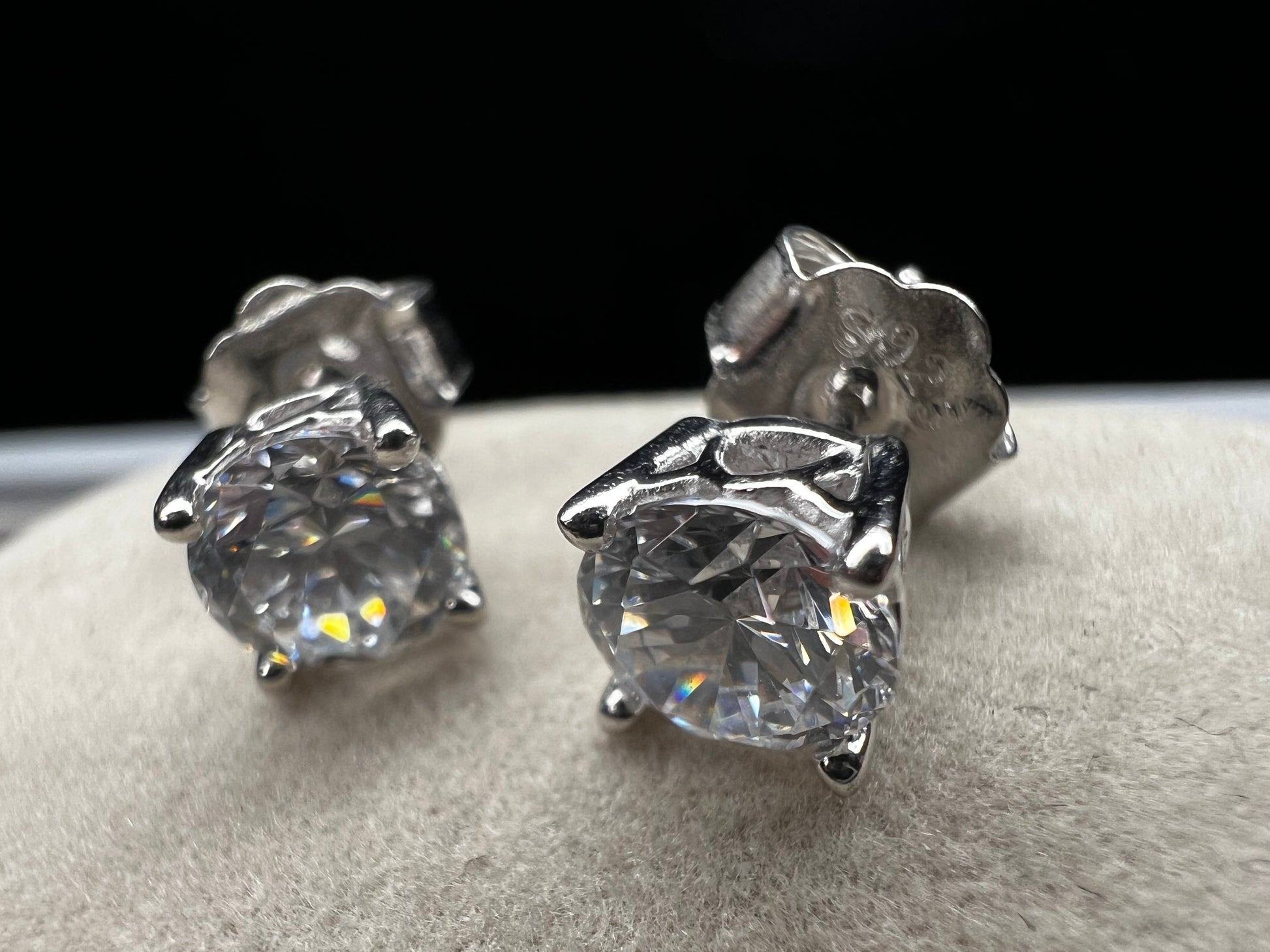 These sterling silver and CZ earrings combine timeless elegance with modern sparkle. Each piece features a generous 6 mm cubic zirconia stone set in premium sterling silver, delivering brilliant shine at a fraction of the cost of diamonds. Perfect for everyday wear or special occasions, these earrings offer versatile style that complements any wardrobe.