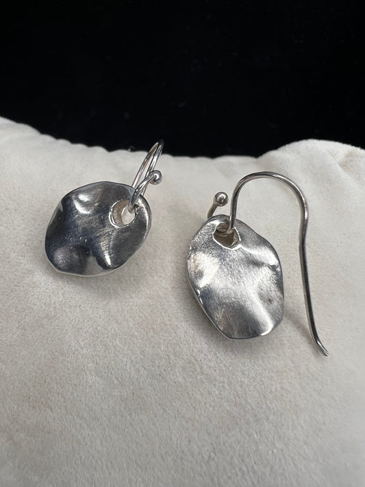 These sterling silver drop earrings feature a sophisticated matte finish that enhances their contemporary appeal.