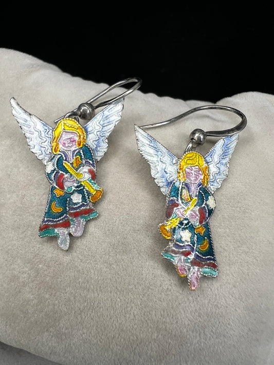 These sterling silver enameled angel earrings combine expert craftsmanship with delicate design. Perfect for those seeking a meaningful accessory, these earrings offer both elegance and a subtle symbol of protection and grace.