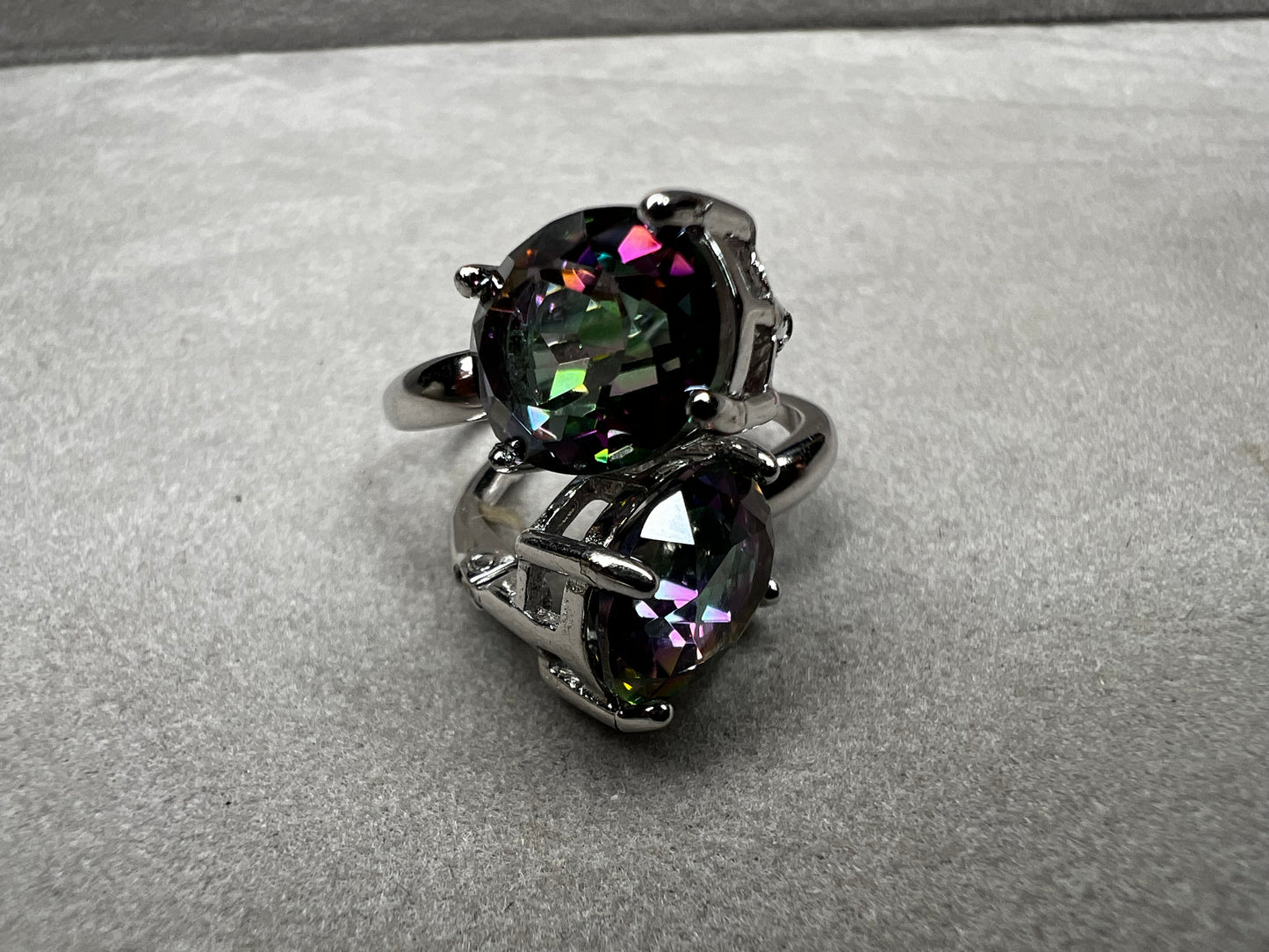 Elevate your everyday elegance with these stunning sterling silver mystic topaz earrings. Each piece showcases a radiant lab-created mystic topaz stone measuring 10 mm x 8 mm, displaying mesmerizing rainbow hues that catch the light beautifully. Crafted from genuine sterling silver, these earrings offer a perfect balance of sophistication and eye-catching sparkle.