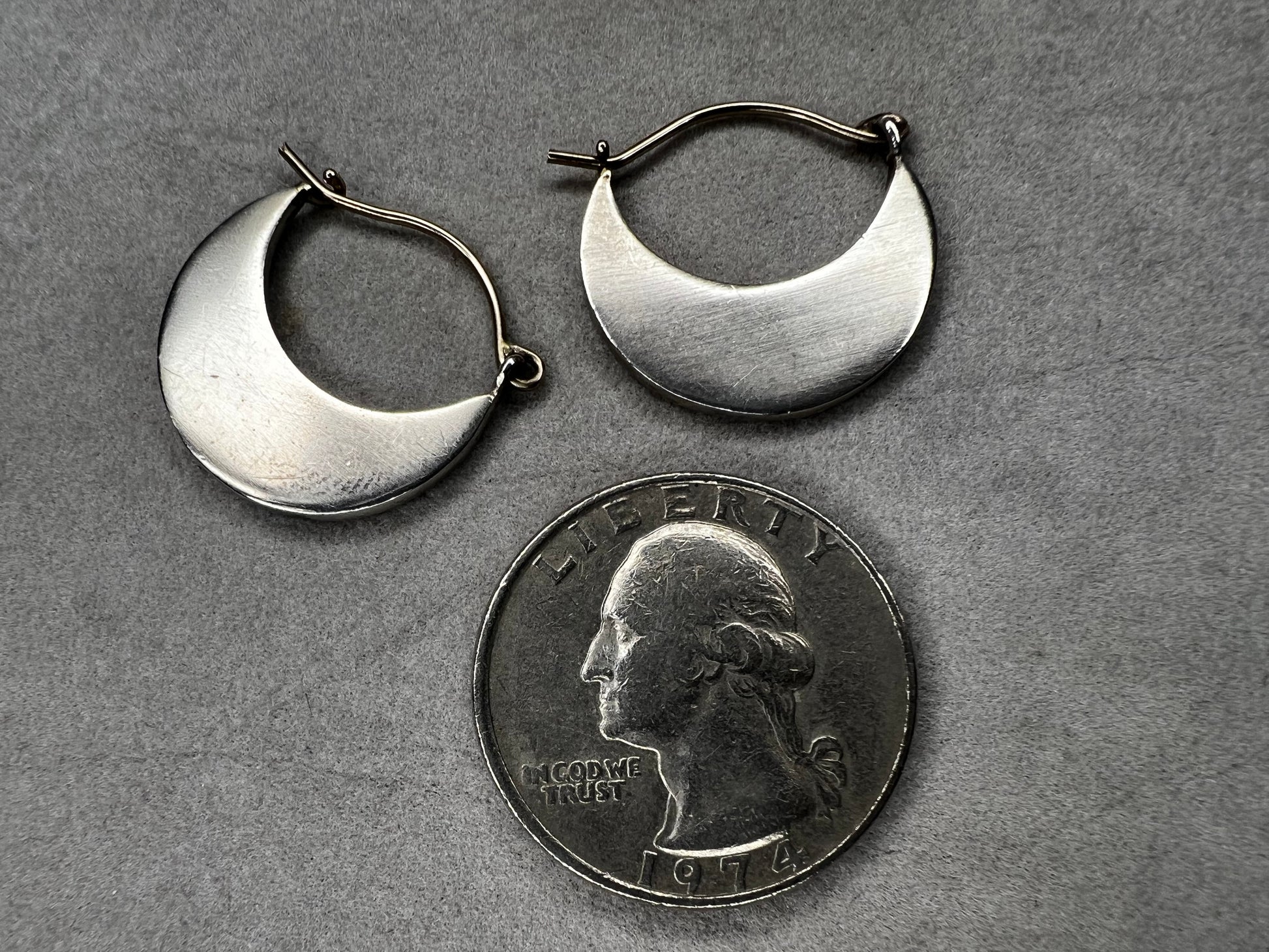 These sterling silver half moon earrings feature a brushed finish on the bottom half, paired with gold overlays on the top hooks. Combining silver and gold tones, they offer a modern, versatile style that complements everyday wear while adding an elegant touch.
