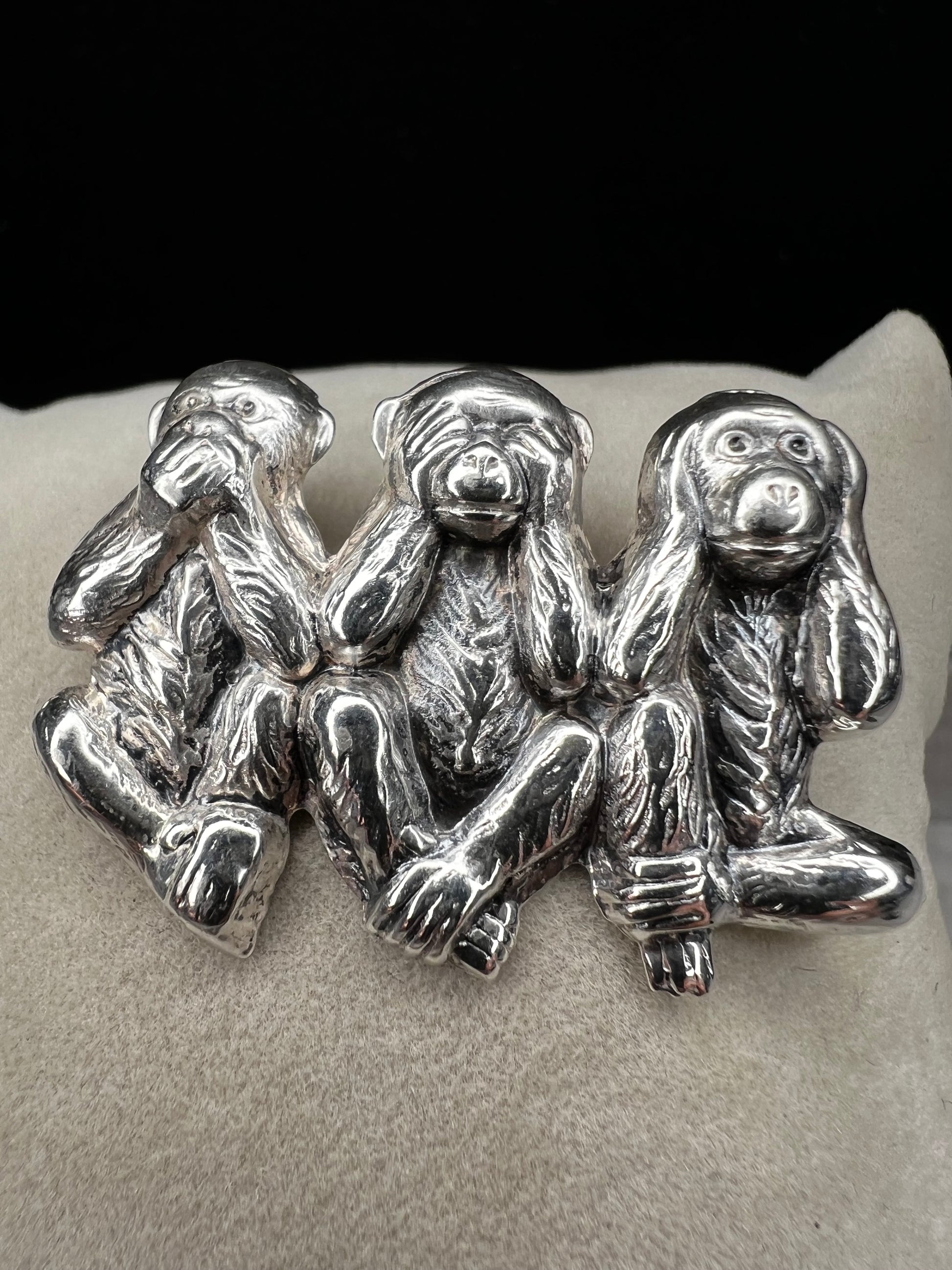 This charming vintage Beau Sterling Silver brooch captures the iconic "see no evil, speak no evil, hear no evil" trio of monkeys in timeless sterling silver. A classic symbol of wisdom and playfulness, this piece adds character to any collection. Perfect for vintage jewelry enthusiasts or as a meaningful gift, it combines nostalgic appeal with quality craftsmanship. The detailed design and sterling silver construction make it a versatile accessory for both everyday wear and special occasions.