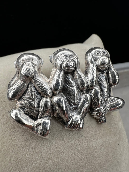 This charming vintage Beau Sterling Silver brooch captures the iconic "see no evil, speak no evil, hear no evil" trio of monkeys in timeless sterling silver. A classic symbol of wisdom and playfulness, this piece adds character to any collection. Perfect for vintage jewelry enthusiasts or as a meaningful gift, it combines nostalgic appeal with quality craftsmanship. The detailed design and sterling silver construction make it a versatile accessory for both everyday wear and special occasions.