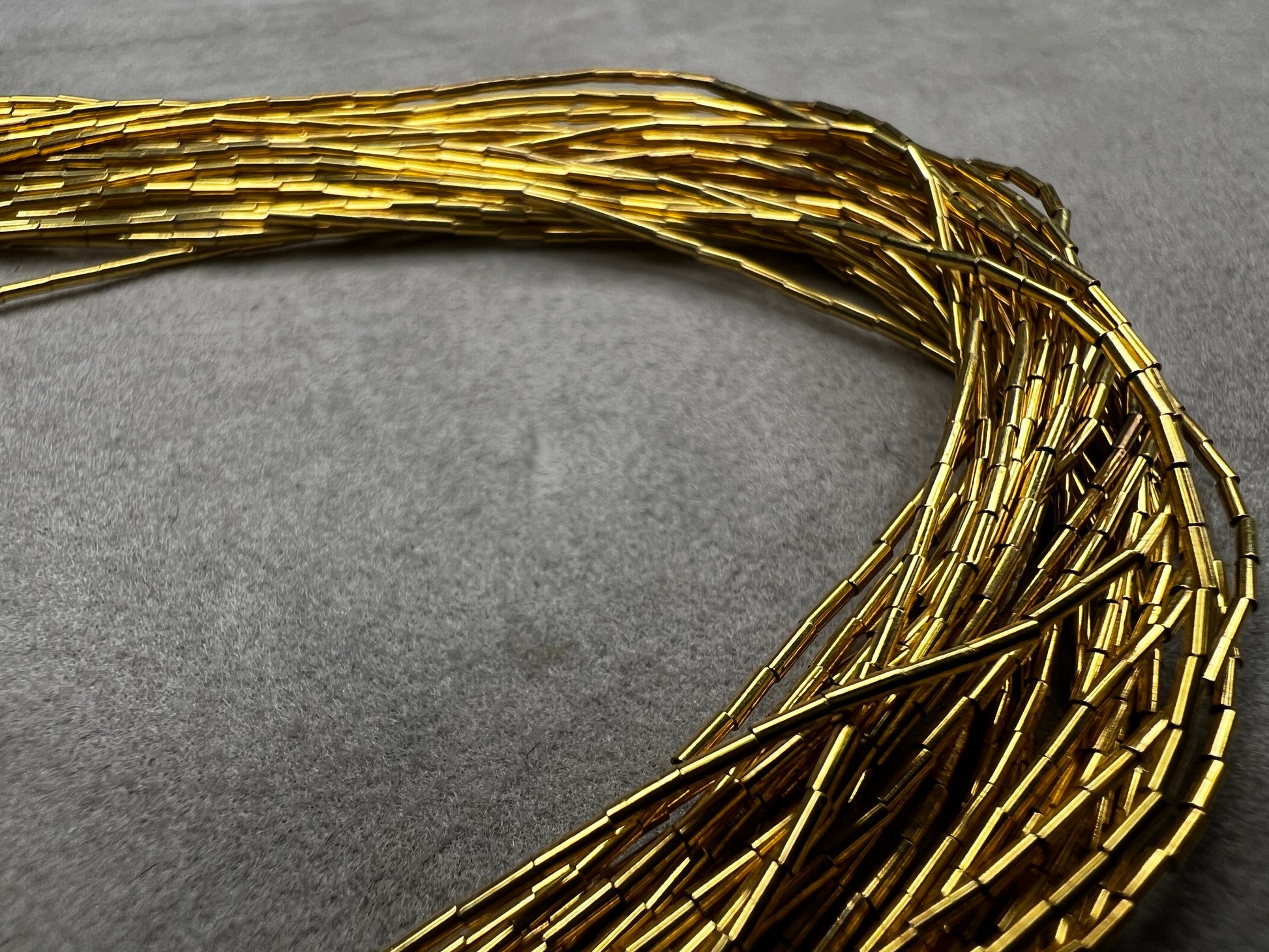 This is a striking gold over sterling silver necklace, featuring the iconic liquid-sterling design. The fluid, sculptural form creates visual movement and dimension, while the gold overlay adds warmth and luxury to the cool brilliance of sterling silver. With substantial length and thickness, this piece commands attention as a standalone statement.