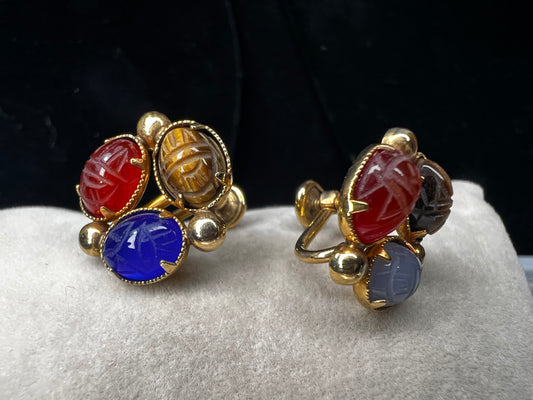 These Bal Ron gold-filled earrings feature three natural stone scarabs on each piece. Designed as screw-back earrings, they offer a unique, comfortable option for those without pierced ears. The combination of natural stones adds a subtle yet distinctive mix of colors, making these earrings an ideal choice for anyone seeking both elegance and individuality.