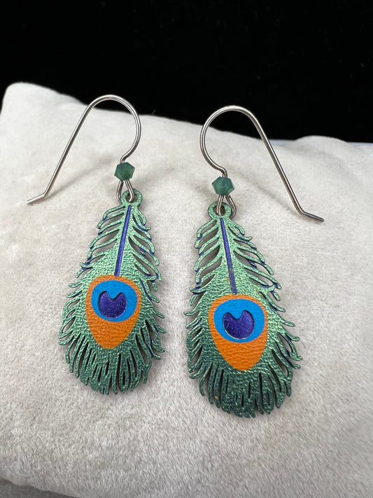 These sterling silver earrings showcase a unique design inspired by peacock feathers, enhanced with vibrant enamel detailing.