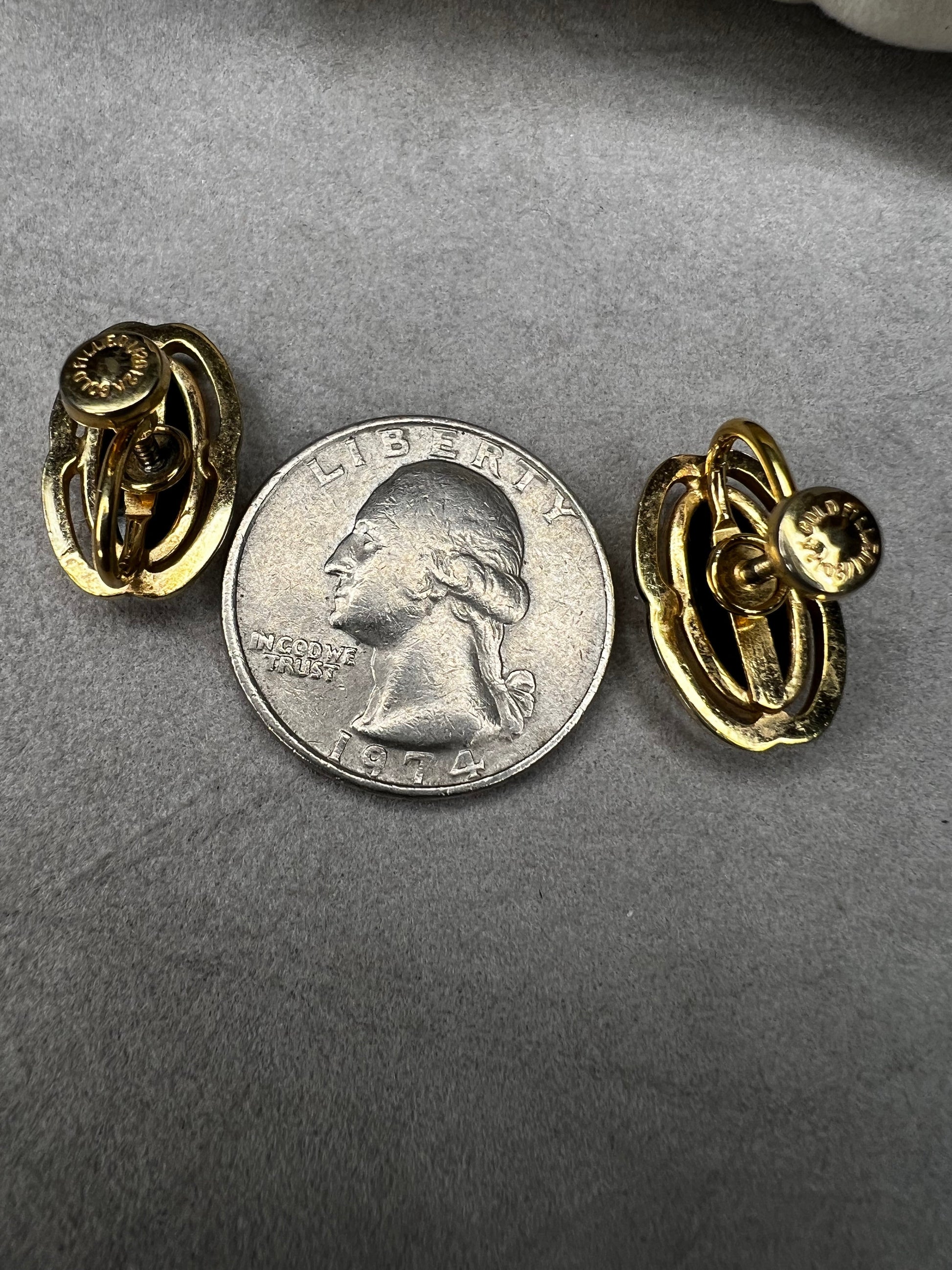 These screw-back earrings feature a beautiful oval piece of jet set in a stylish gold-filled frame.