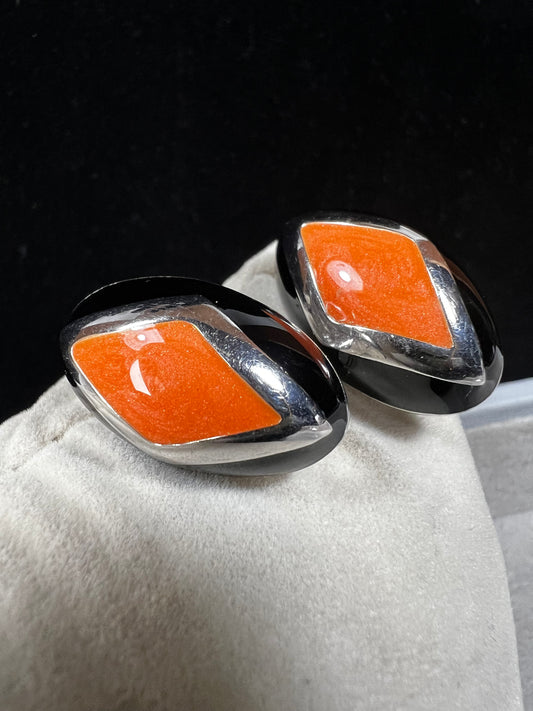 Add a vibrant touch to your collection with these vintage Italian earrings. Crafted from sterling silver, they feature striking orange and black inlay.