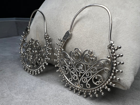 These sterling silver earrings offer a distinctive design that balances boldness with subtlety. Their intricate detailing adds sophistication without overwhelming your look.