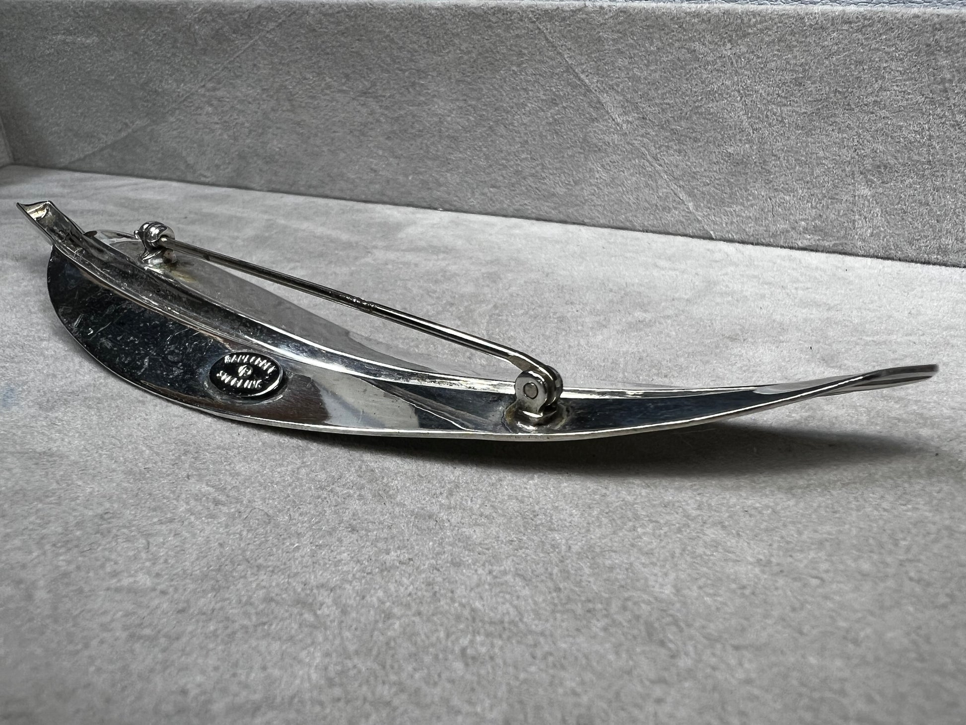 This Danecraft sterling silver brooch features an elegant leaf design measuring just over 4 inches, making it a standout accessory.