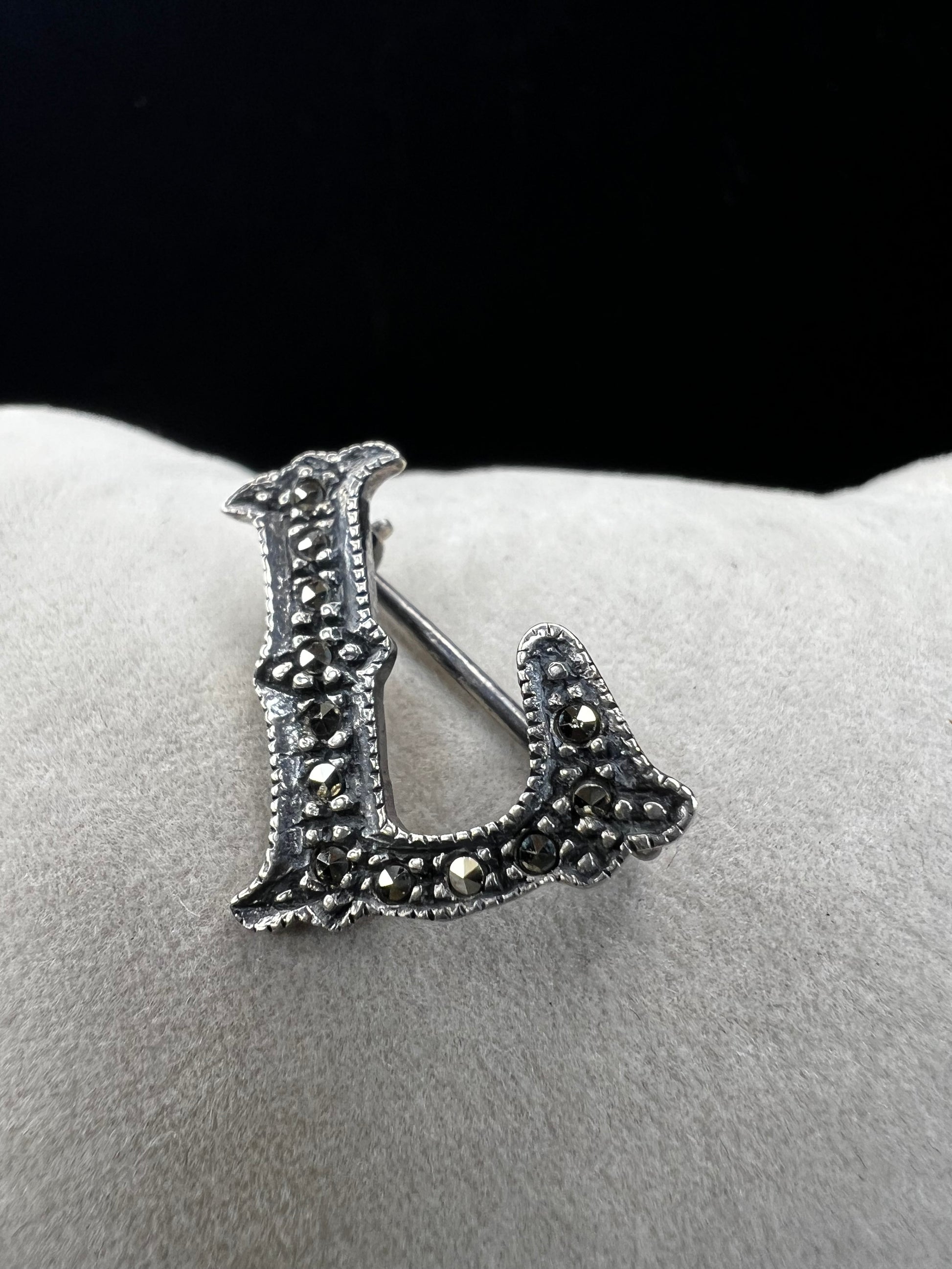 This sterling silver and marcasite pin shaped like an "L" adds a subtle, timeless vintage charm to any outfit. Its delicate design offers a perfect way to personalize your look with a touch of classic elegance.