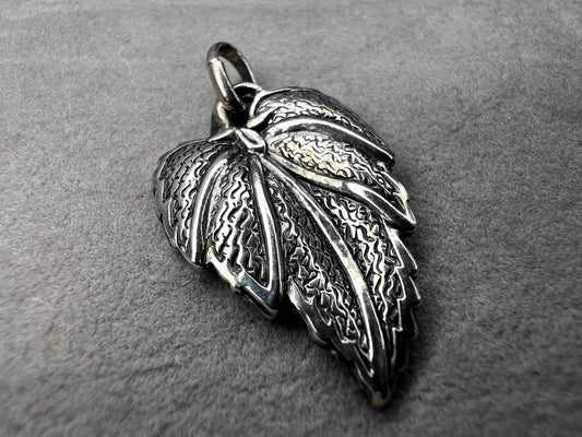 This 1-inch leaf crafted from sterling silver offers versatile wear as either a pendant or charm. Its elegant design brings a natural touch to your jewelry, making it a meaningful addition to any collection.
