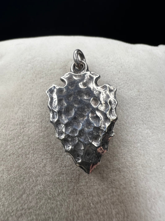 This sterling silver arrowhead, measuring 1 inch, offers versatile wear as either a charm or a pendant. Its sleek design adds a subtle touch of elegance, making it a meaningful accessory that complements any style with ease.
