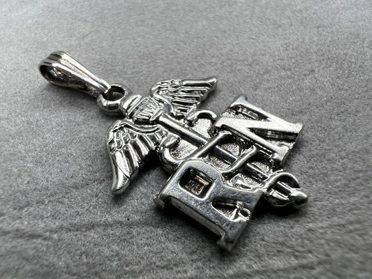 Celebrate the dedication of nurses with this vintage sterling silver RN pendant. It serves as a meaningful symbol of commitment and care. Perfect for everyday wear or as a thoughtful gift.