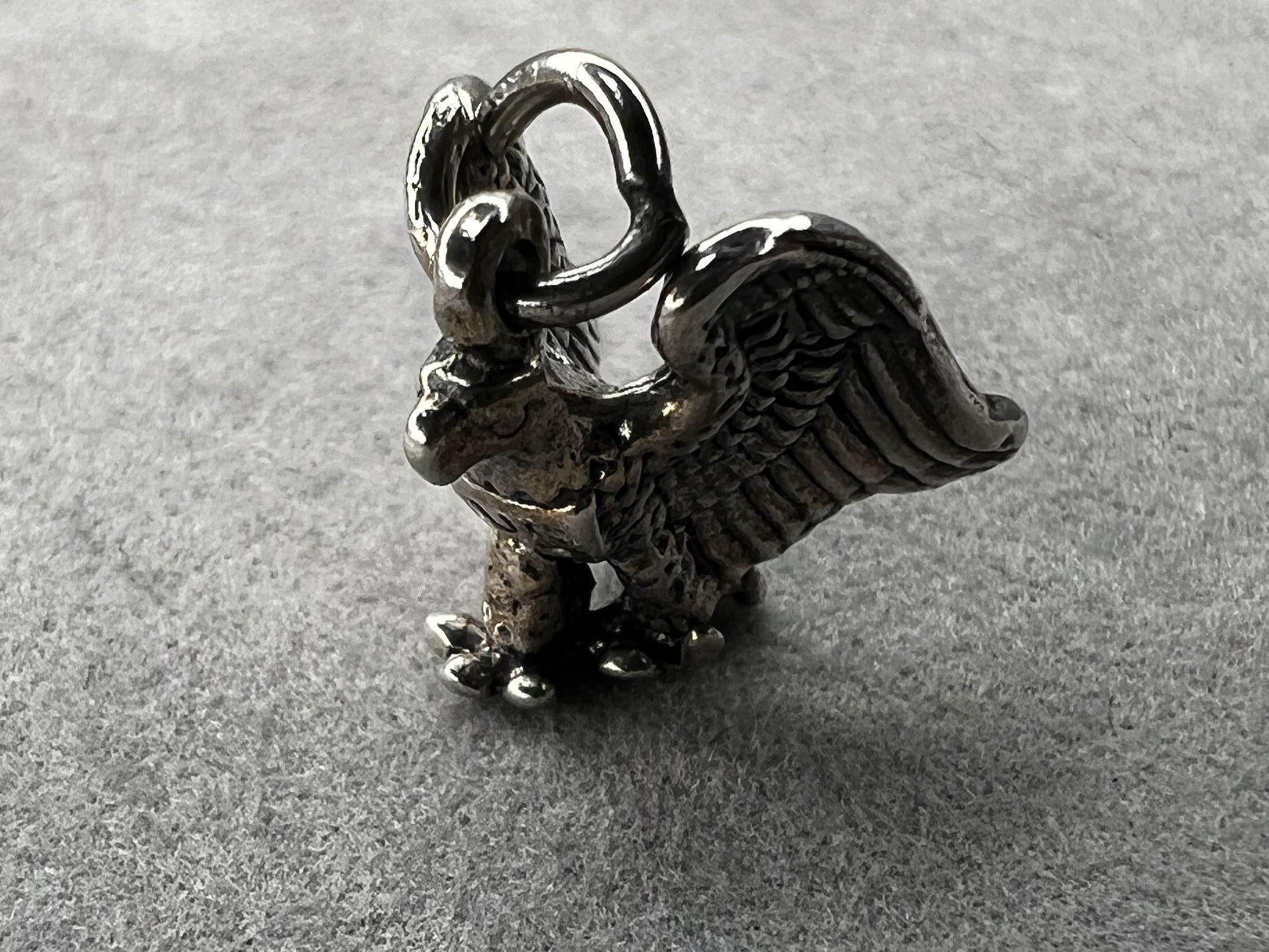 This eagle charm is expertly crafted from solid sterling silver. Its detailed design symbolizes strength and freedom, making it a perfect piece to celebrate your personal style and values.