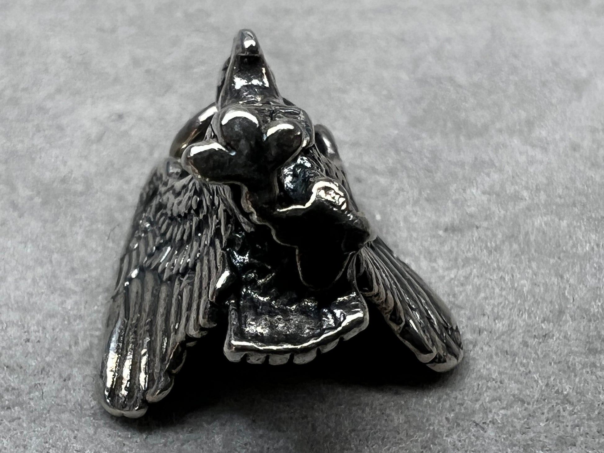 This eagle charm is expertly crafted from solid sterling silver. Its detailed design symbolizes strength and freedom, making it a perfect piece to celebrate your personal style and values.