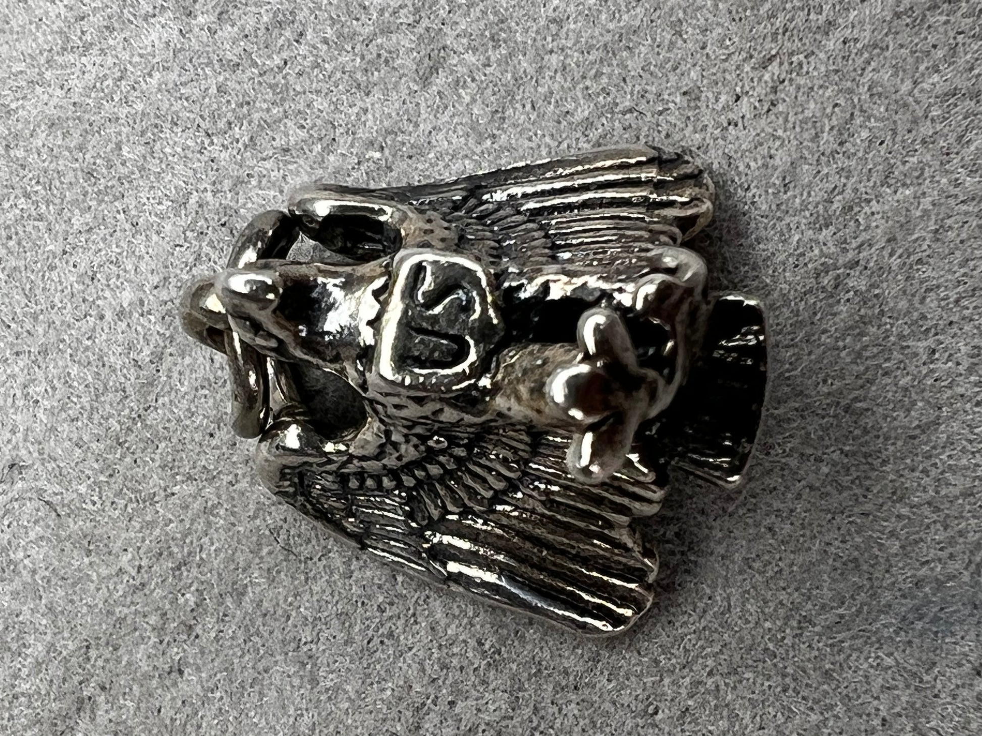 This eagle charm is expertly crafted from solid sterling silver. Its detailed design symbolizes strength and freedom, making it a perfect piece to celebrate your personal style and values.