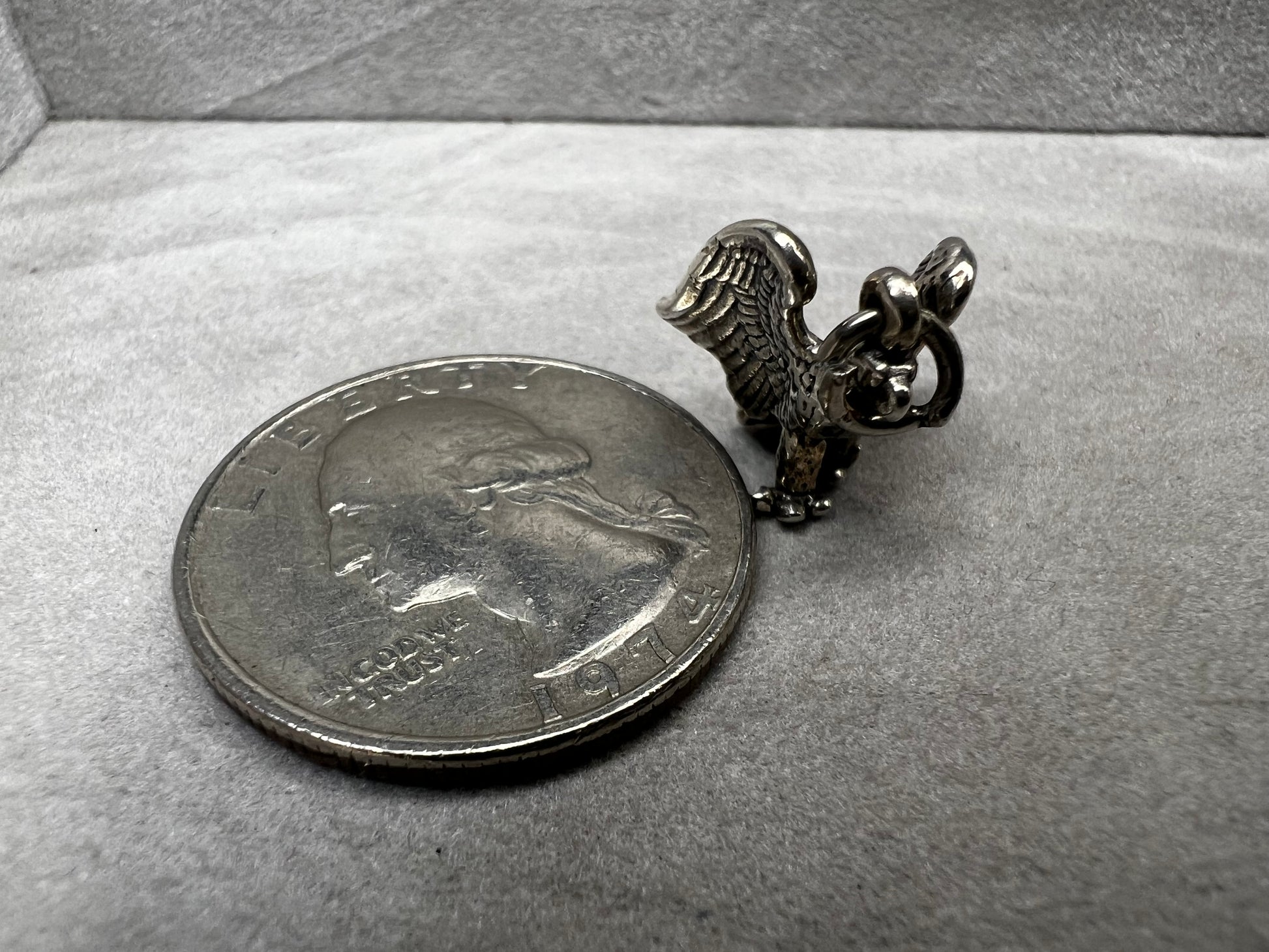 This eagle charm is expertly crafted from solid sterling silver. Its detailed design symbolizes strength and freedom, making it a perfect piece to celebrate your personal style and values.