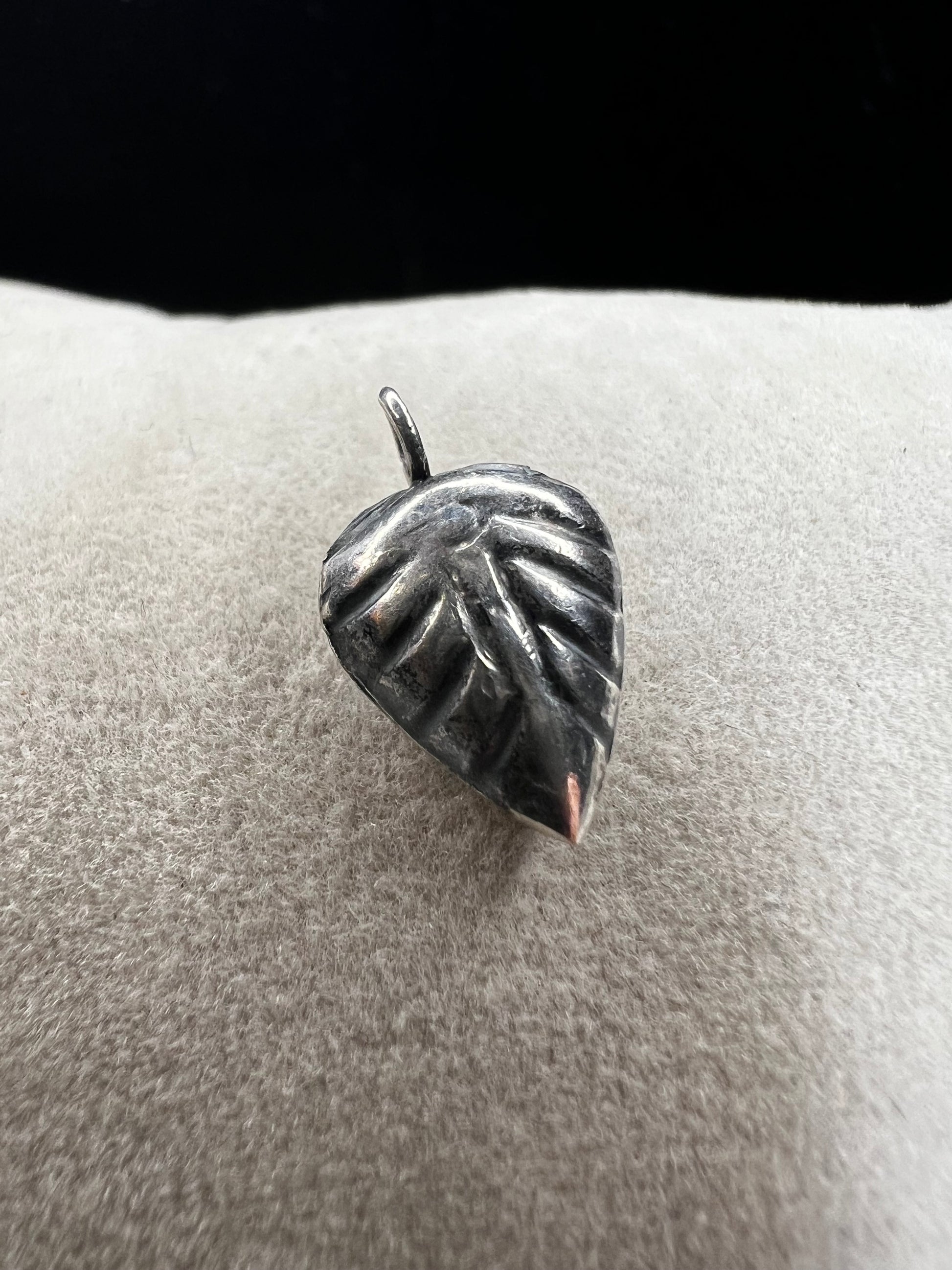 This sterling silver puffed leaf charm features delicate detailing on both sides, adding a subtle touch of nature-inspired elegance to your jewelry. Designed to be attached easily with a jump ring, it’s perfect for customizing your bracelet or necklace with a meaningful accent.
