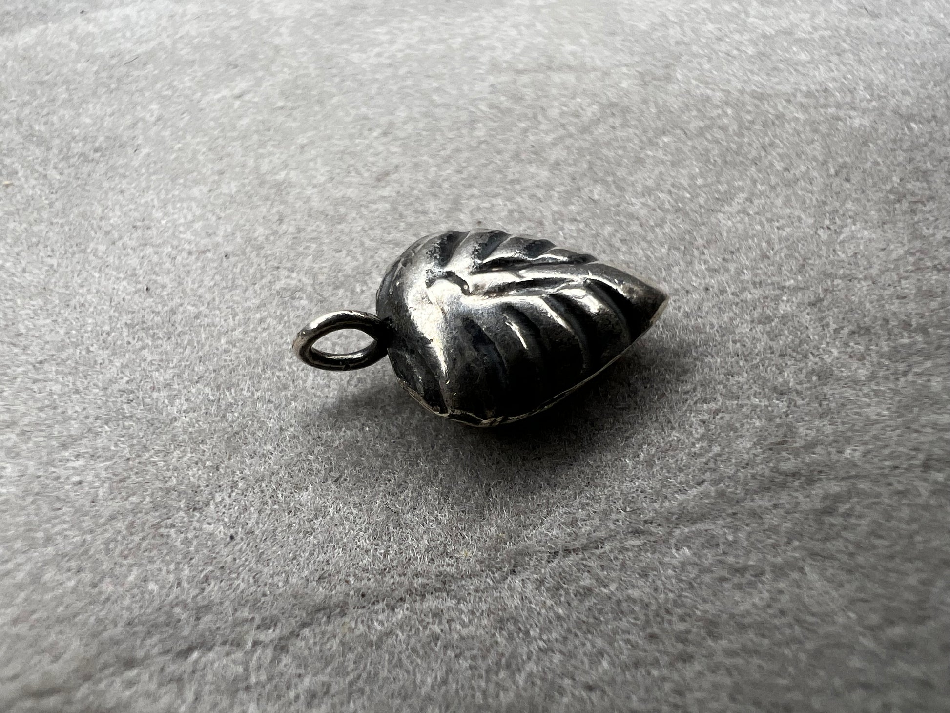 This sterling silver puffed leaf charm features delicate detailing on both sides, adding a subtle touch of nature-inspired elegance to your jewelry. Designed to be attached easily with a jump ring, it’s perfect for customizing your bracelet or necklace with a meaningful accent.