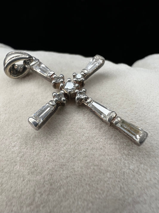 This vintage 1 1/4" sterling silver cross pendant features sparkling rhinestones that enhance its classic design.