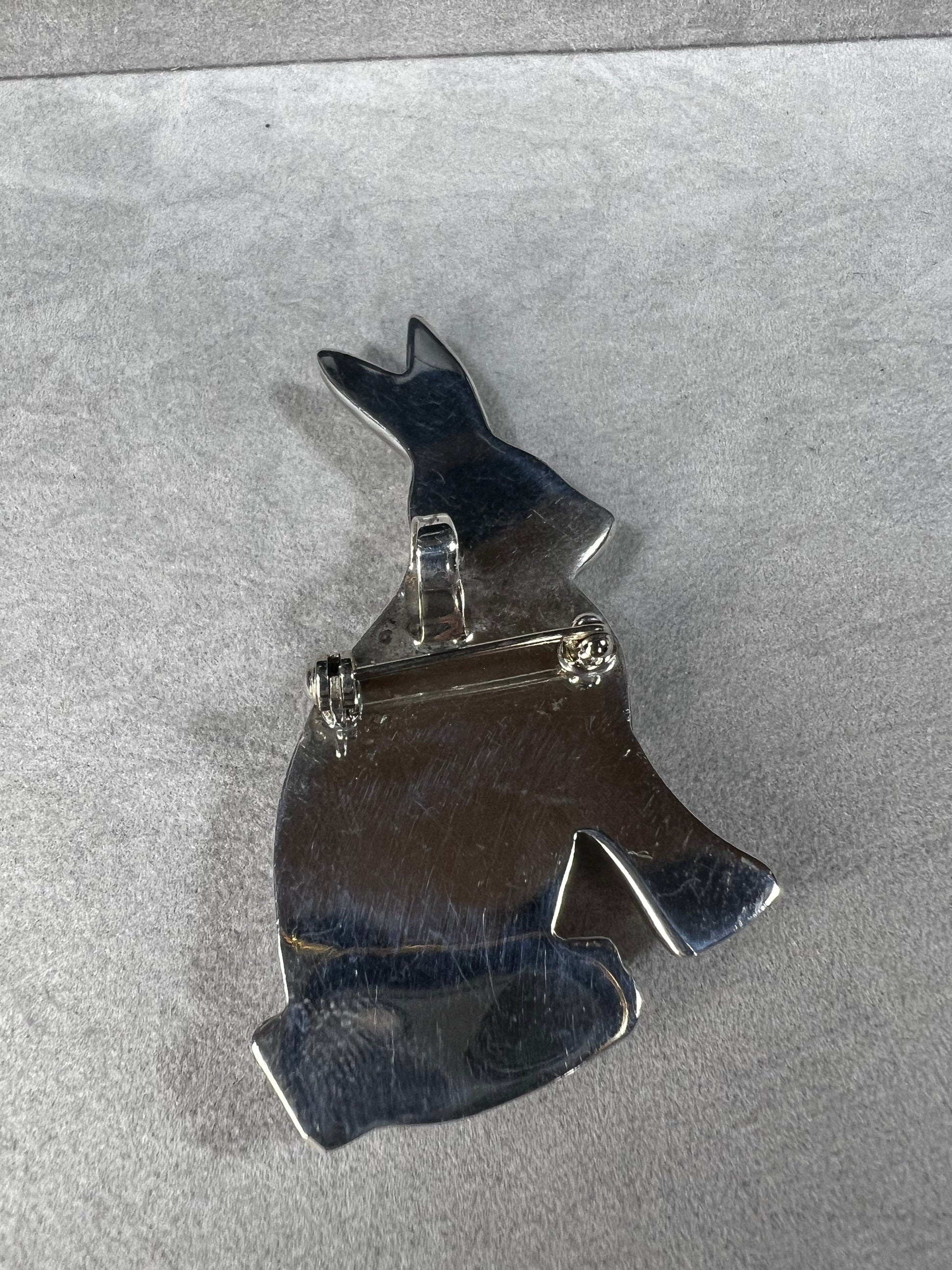 This sterling silver rabbit offers versatile wear as either a pendant or a brooch. Its charming design makes it a delightful addition to any collection, perfect for adding a touch of whimsy and elegance to your style.