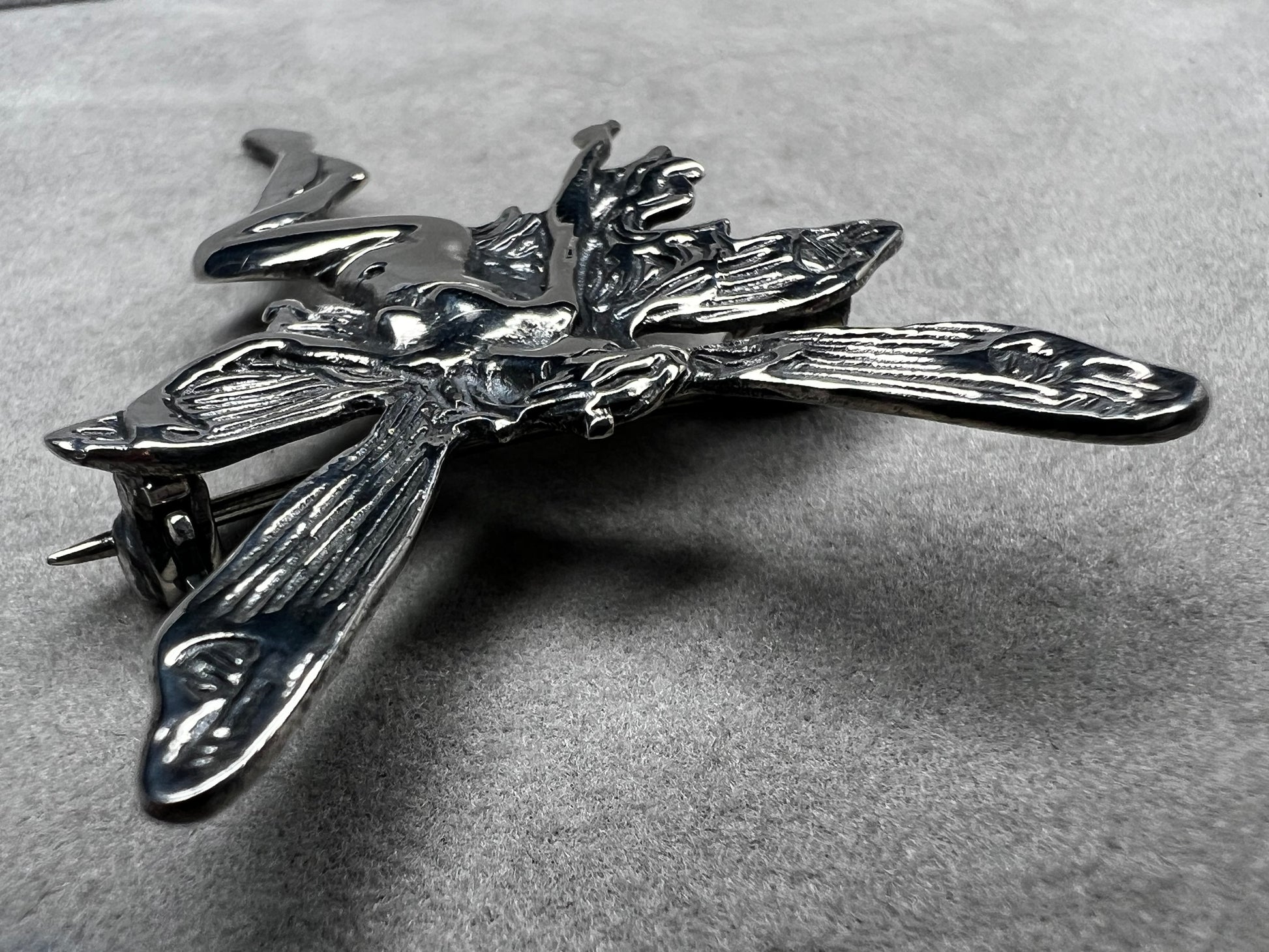 Crafted from sterling silver, this 2" nude goddess fairy brooch from the 1980s adds a unique touch to the right outfit or special occasion.