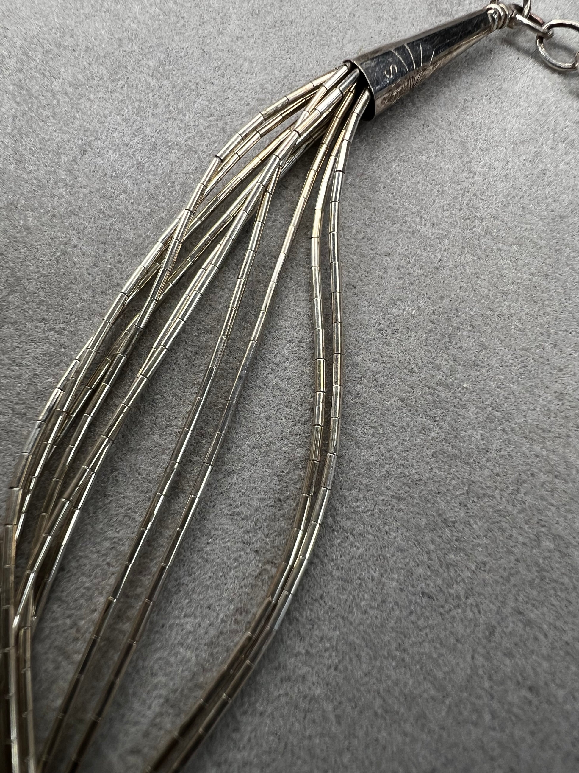 This 18-inch sterling silver "Liquid Sterling" necklace features 10 delicate strands that move gracefully with you, capturing and reflecting light beautifully.