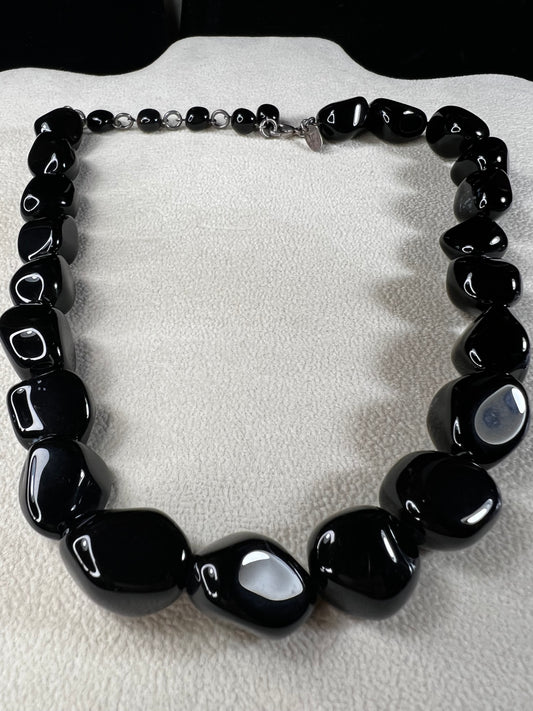 This necklace from LSB Designs features natural black onyx beads and sterling silver, combining striking beauty with lasting durability. Designed to impress, it offers a bold yet elegant accessory that enhances any look.